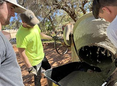 Men working with concrete mixer